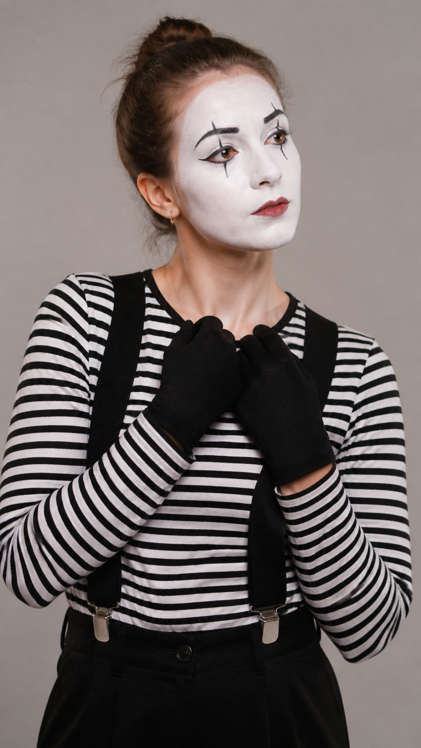 A detailed photograph of a woman wearing a black-and-white striped shirt, white face paint with black eyeliner accent...