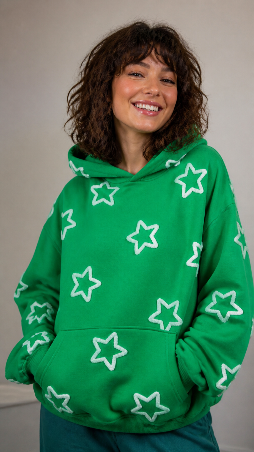 A vibrant photograph of a person wearing a bright green hoodie with white pipe cleaners bent into star shapes glued a...